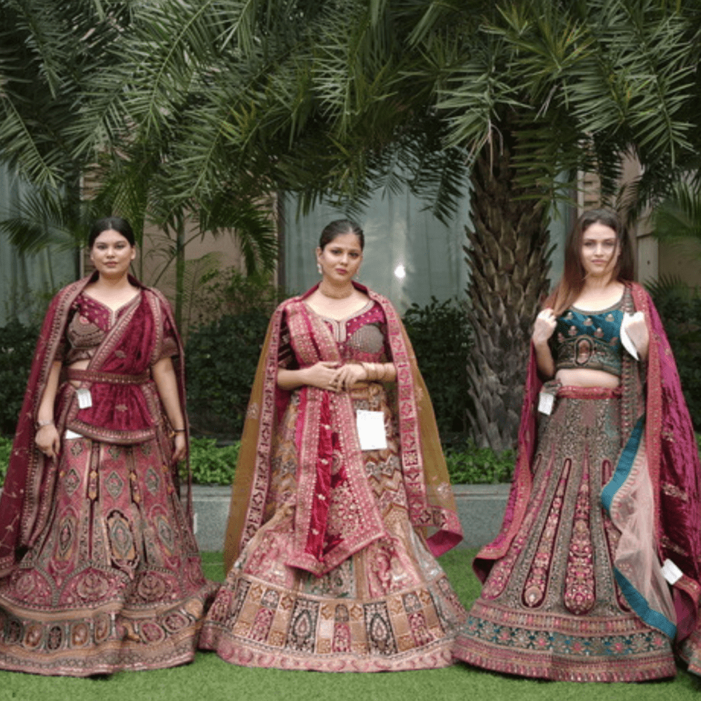 A women displaying Lehengas design on stage.