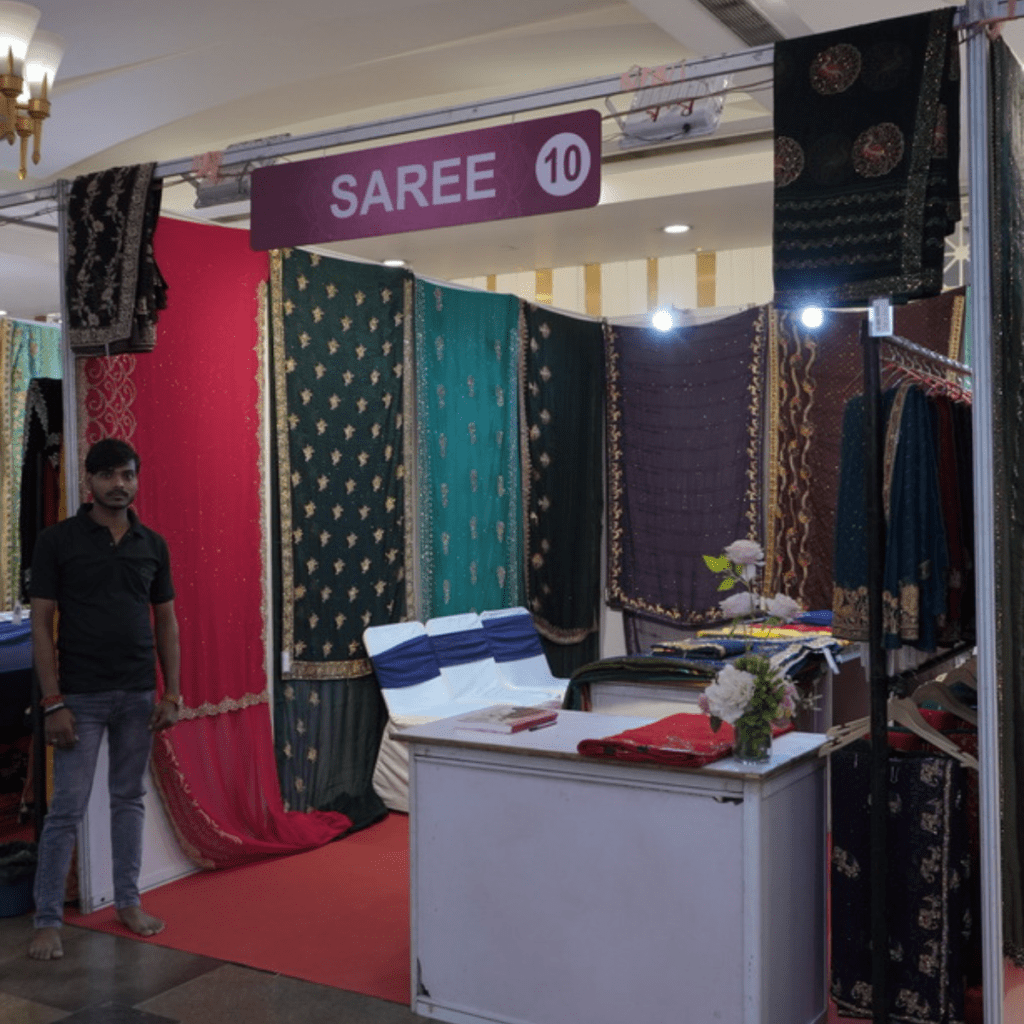 a men showing saree for clients